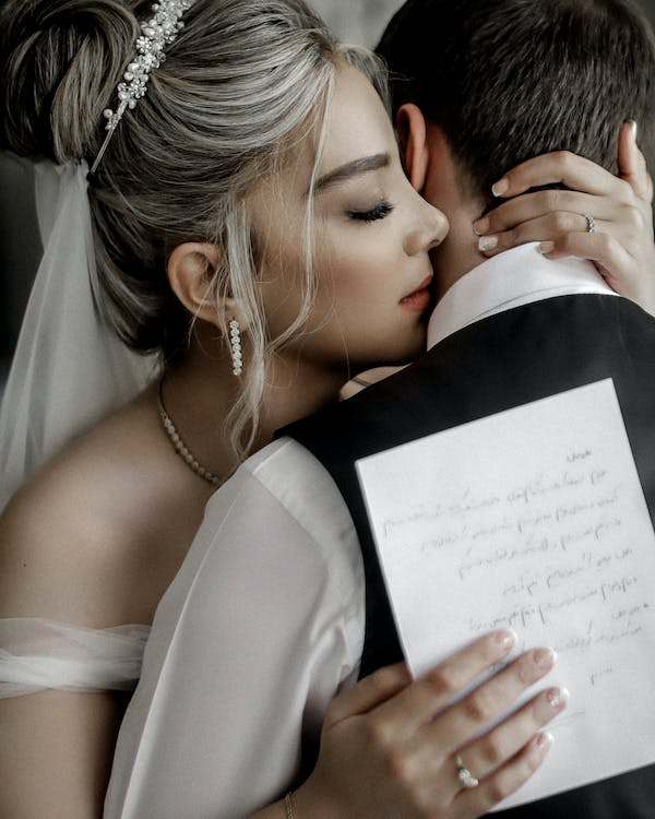 Couple hugging each other and holding a card