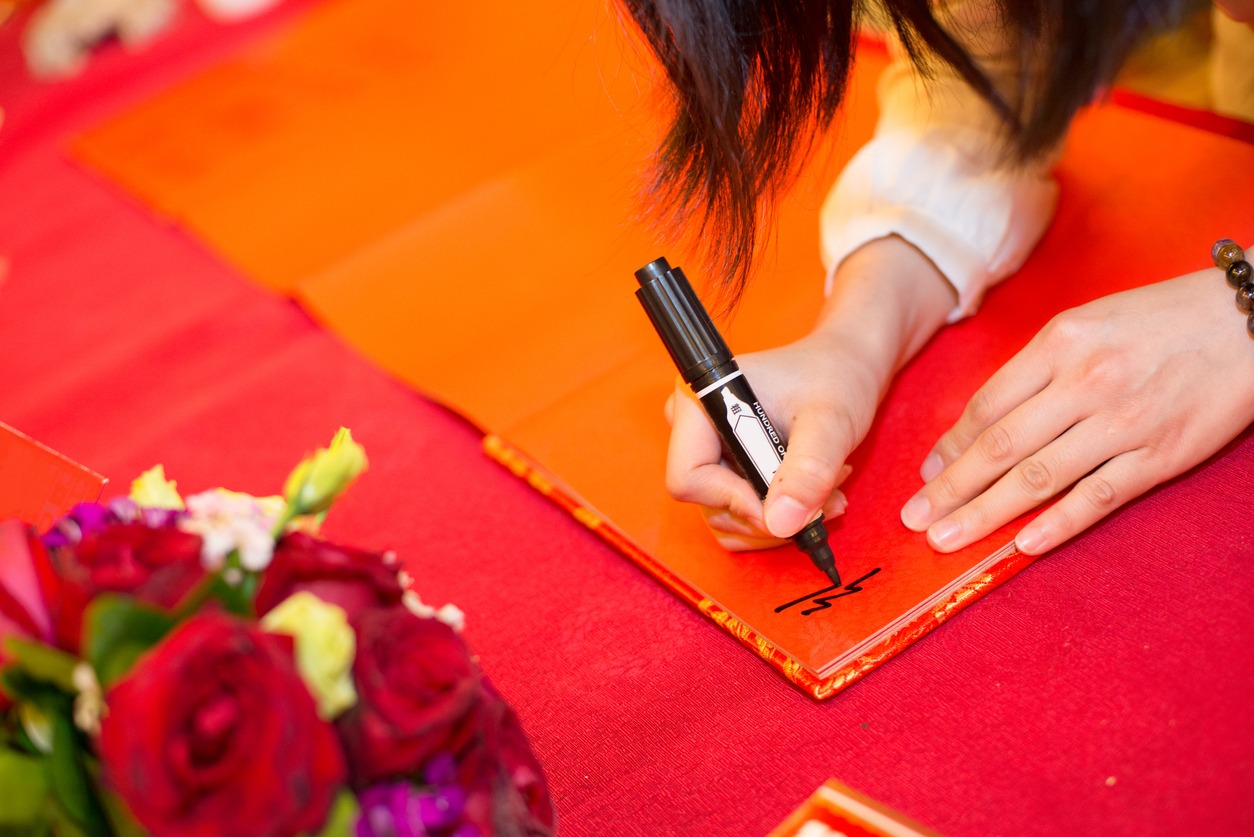 Hand signing on a guest book at party