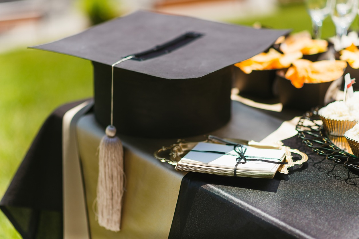 Set-up of a table for the graduation party with a tassel for table decor