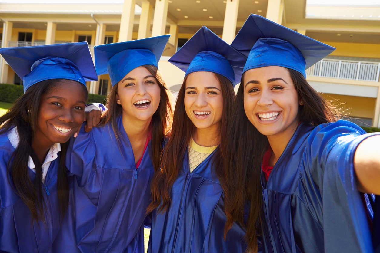 Teenage girls with their tassels celebrating in their home