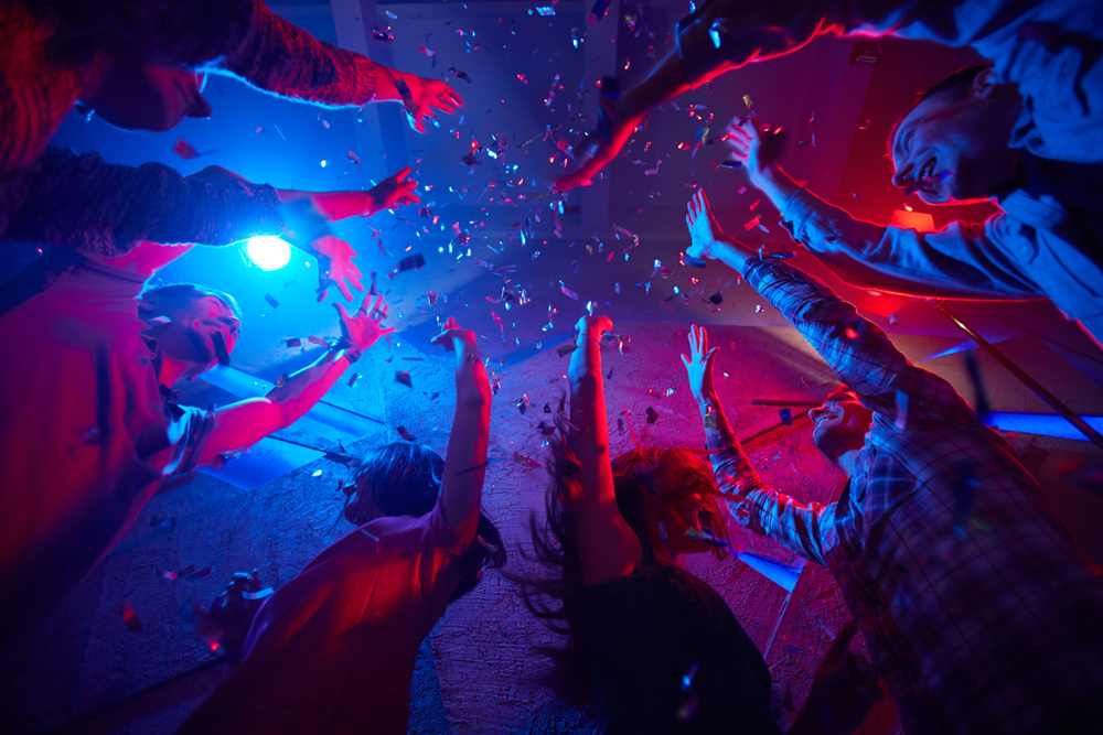 Friends having fun with confetti while dancing