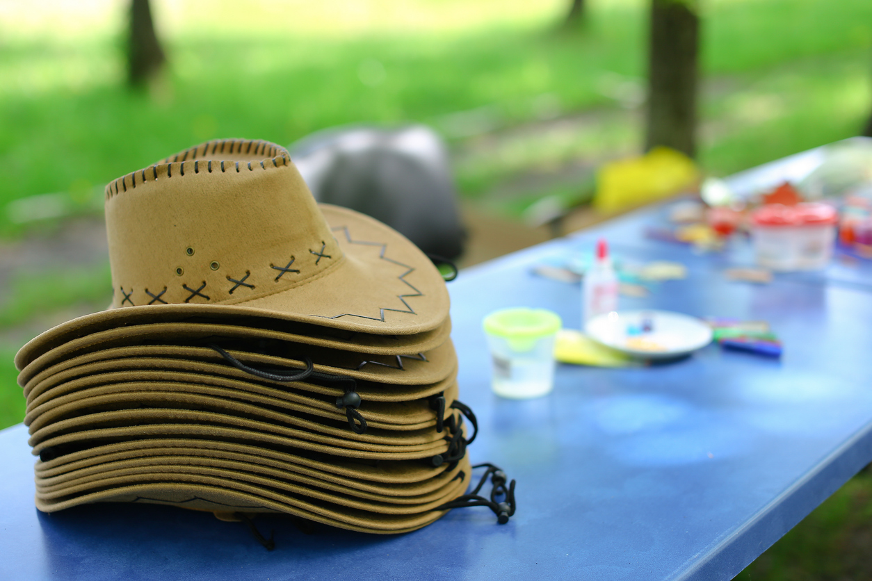cowboy hats stacked on top of one another on a table