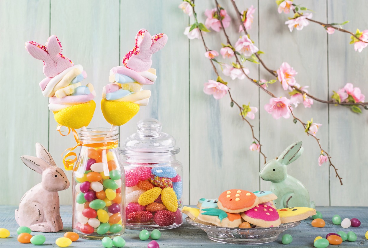Colorful sweets on a green wooden background
