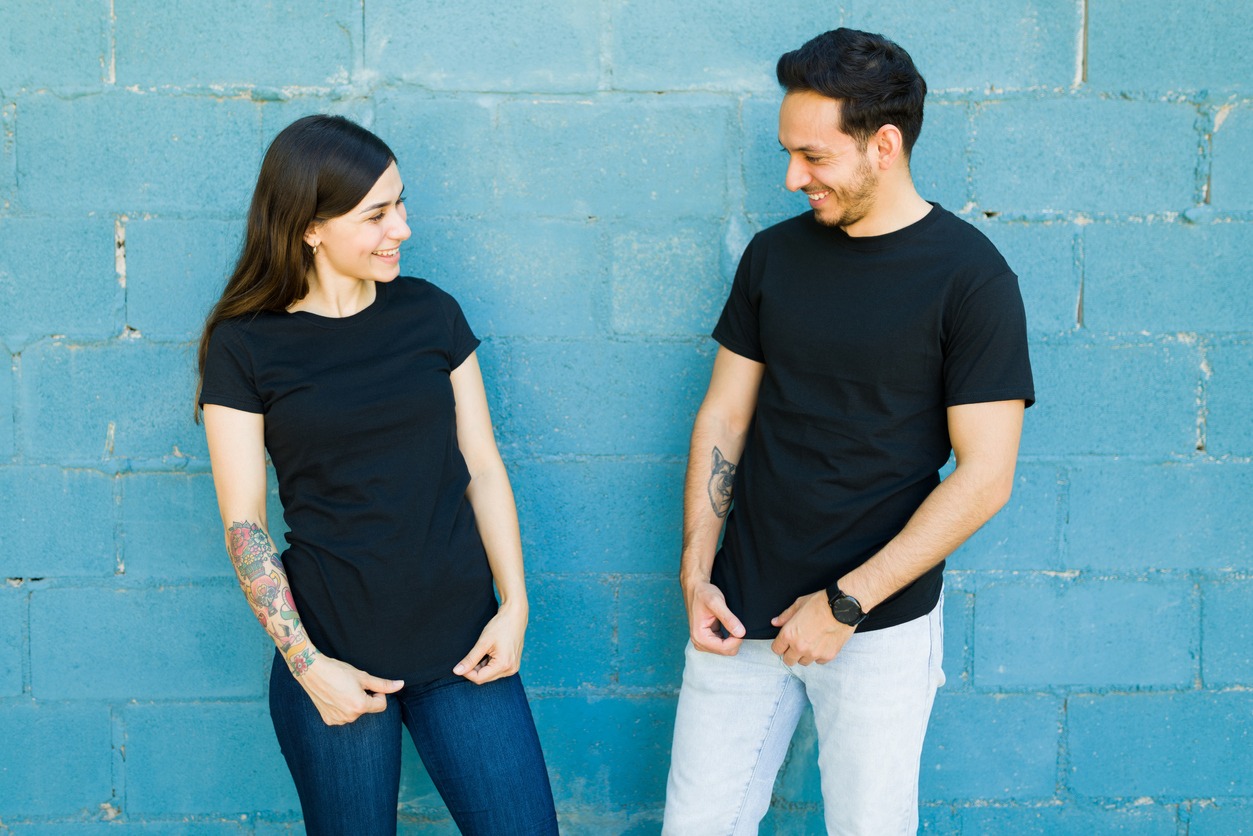 Matching t shirts. Young couple feeling happy after they had t-shirts made with the same designs