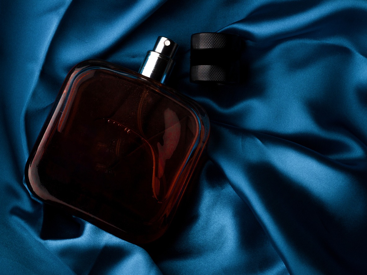 body perfume in blue cloth background