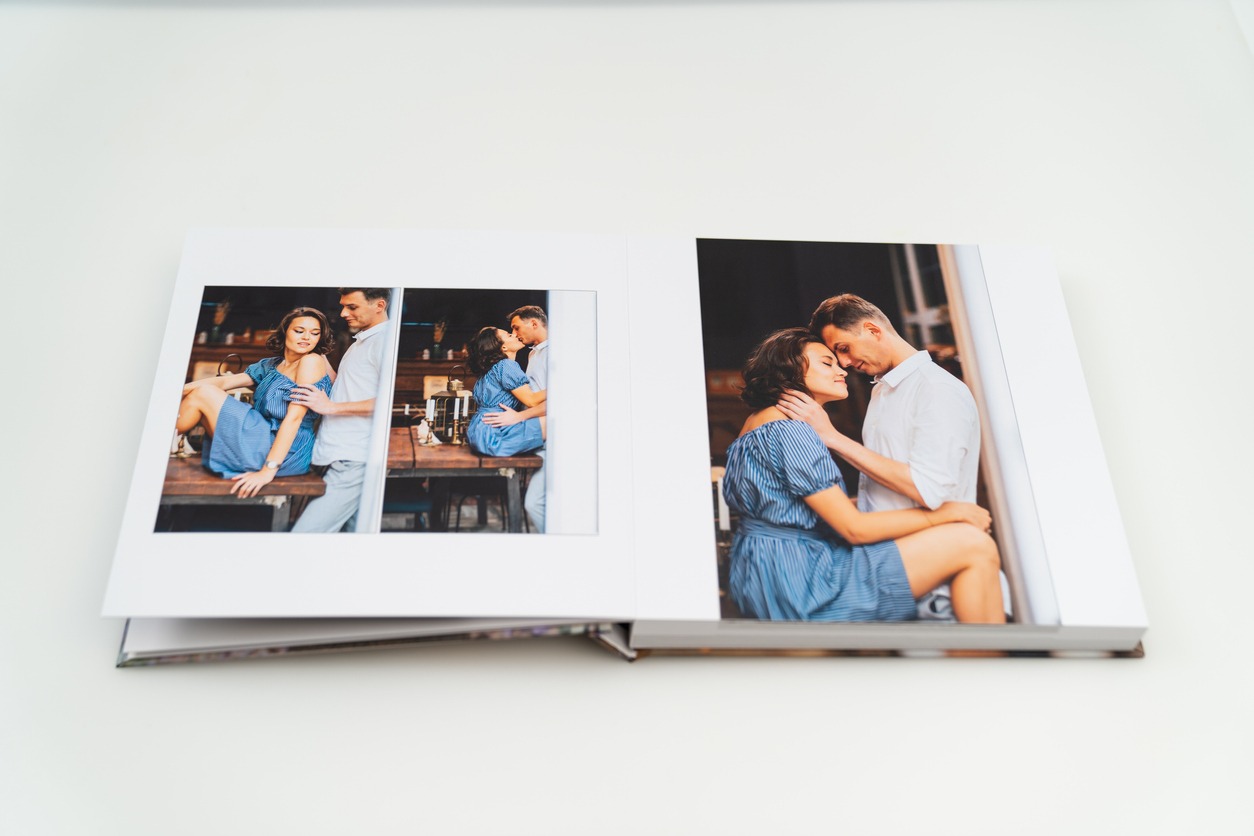the pages of the photobook from photo shoots of a a beautiful happy couple. grainy paper texture. photo design in the album. Memory. Designer. white background
