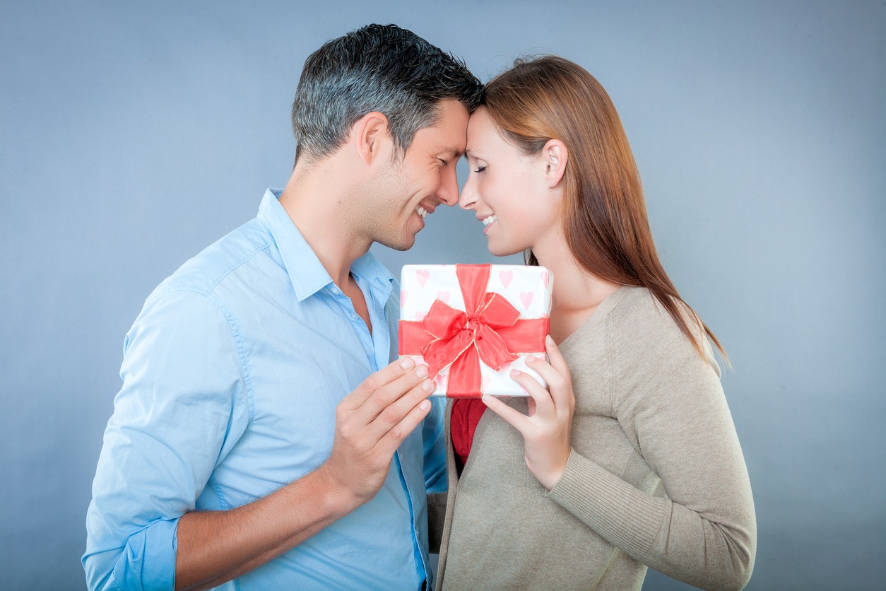 happy couple holding together a present