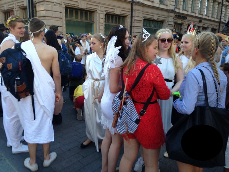 Group of college students wearing toga costumes outdoors 