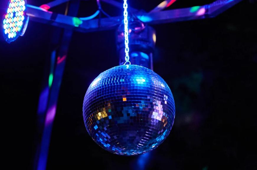 a lighted disco ball hanging from the ceiling