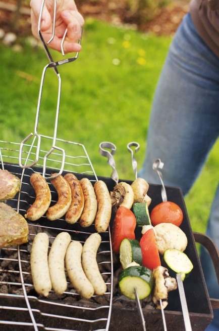 Grilling sausages at a grill