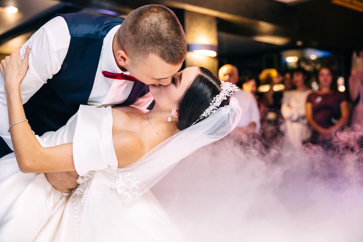 Kissing couple in their wedding outfits