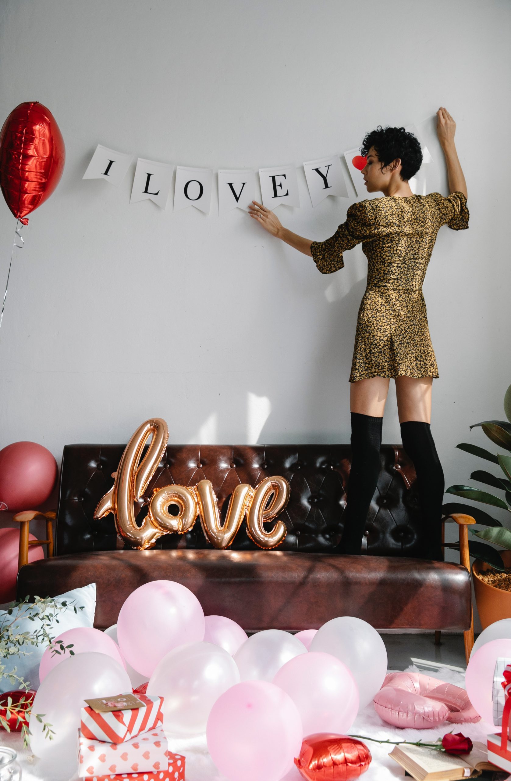 a woman decorating a photo booth for valentine's day