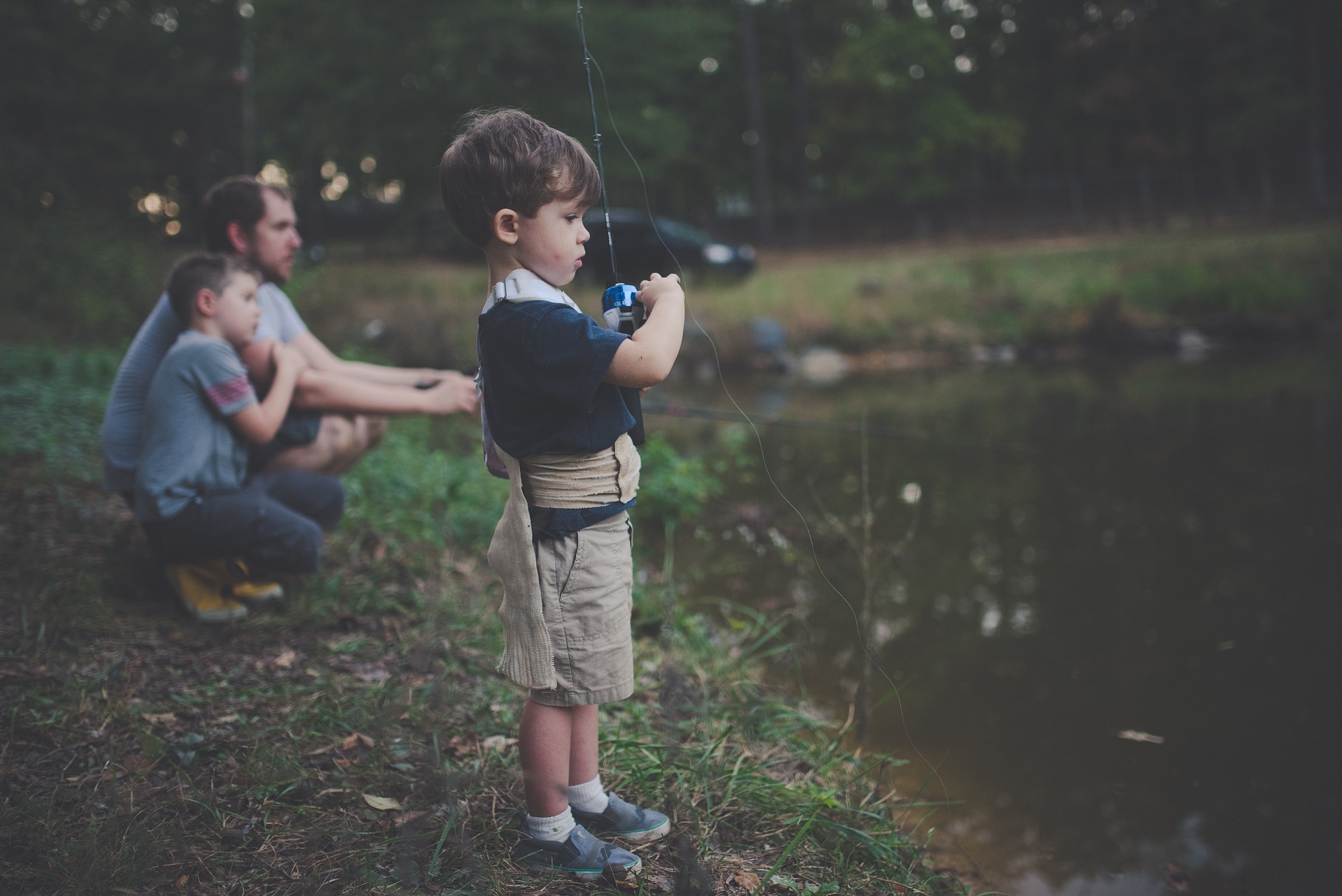 boy fishing with a man
