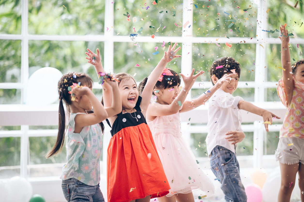children playing with confetti and celebrating a birthday