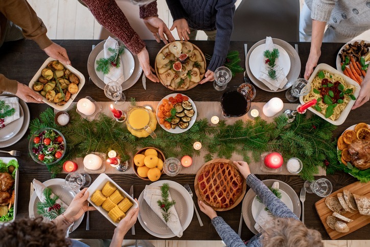 A holiday dinner table with lots of serving dishes with food