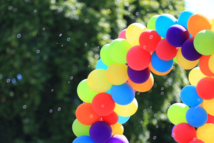 A rainbow-colored balloon arch