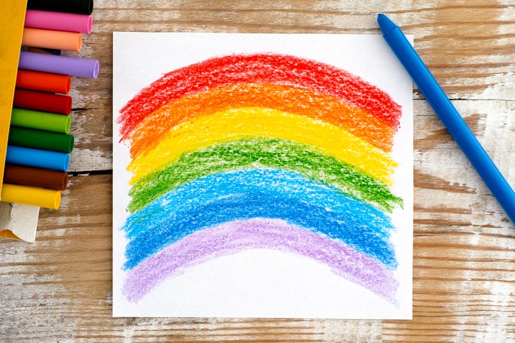 Hand drawing of a rainbow using wax crayons