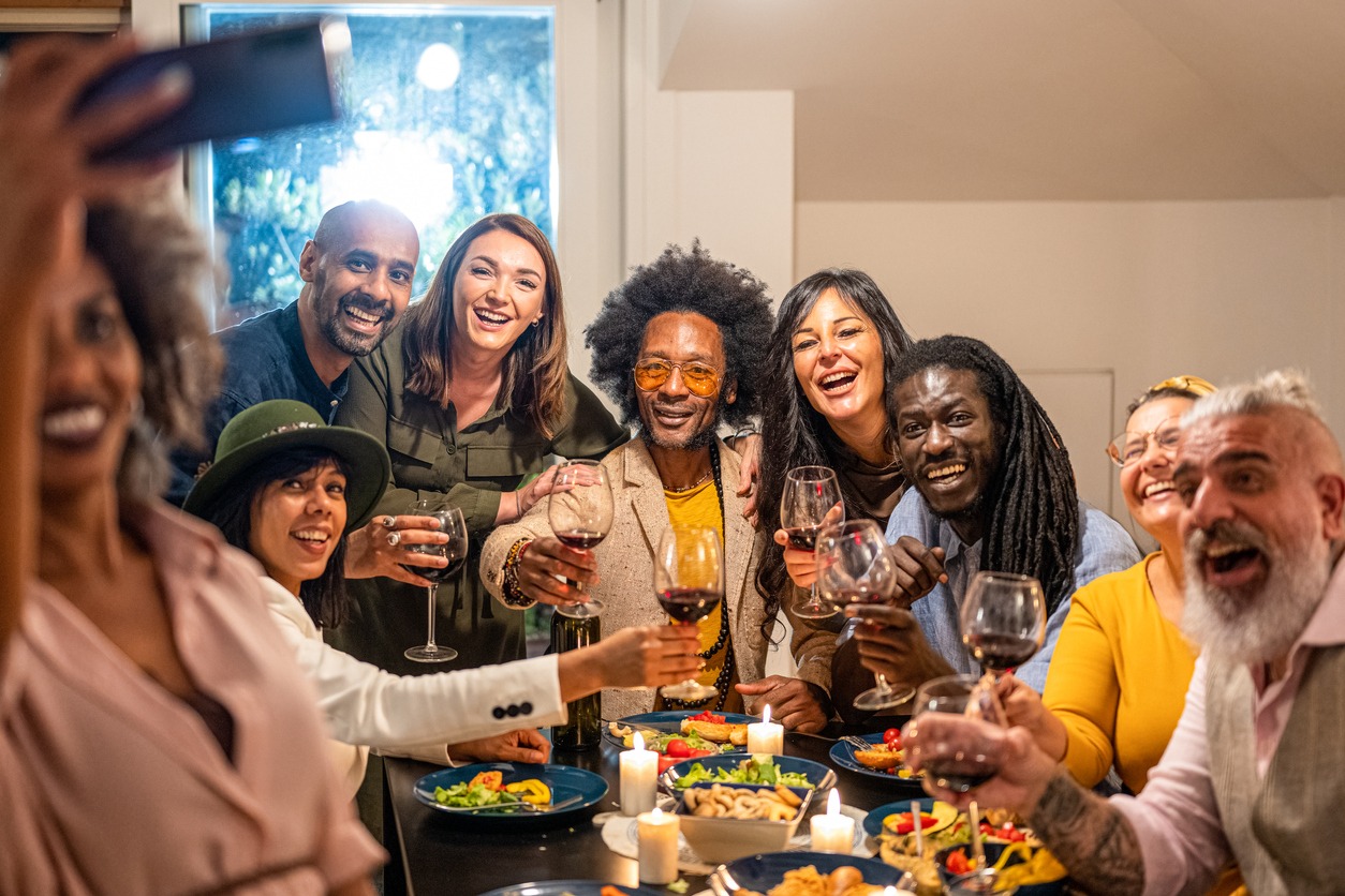 friends toasting and making selfie at dinner party, large group of people having fun and celebrating themselves, social gathering and friendship concept, celebration toast