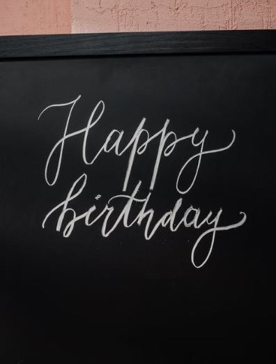 a “Happy Birthday” written on a blackboard