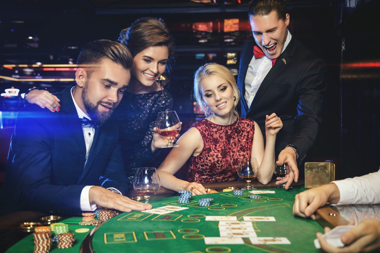 a group of dressed up people playing poker