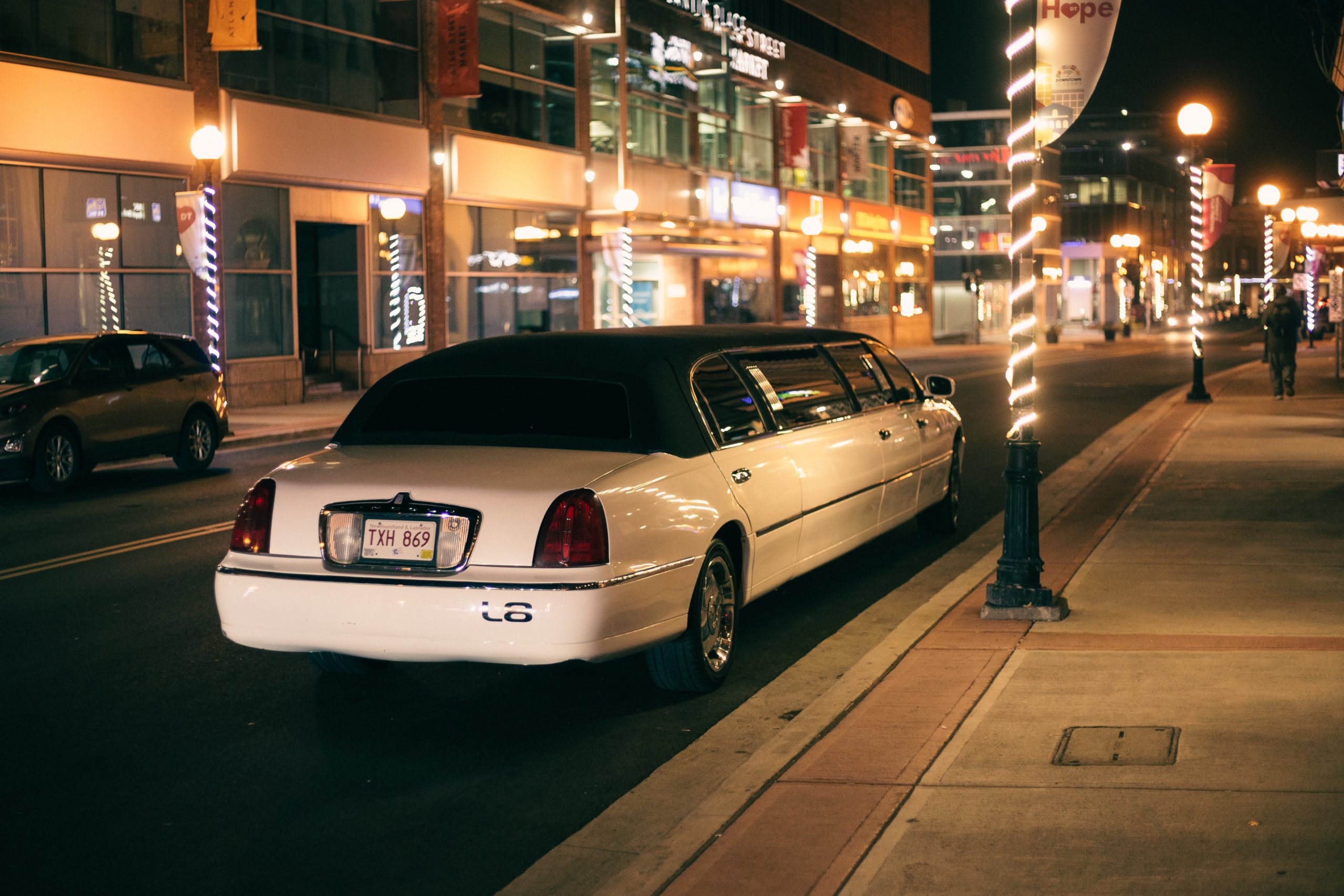a limousine parked at the street side during night
