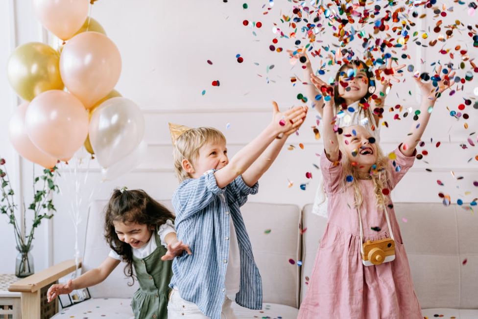 children playing with confetti in a party