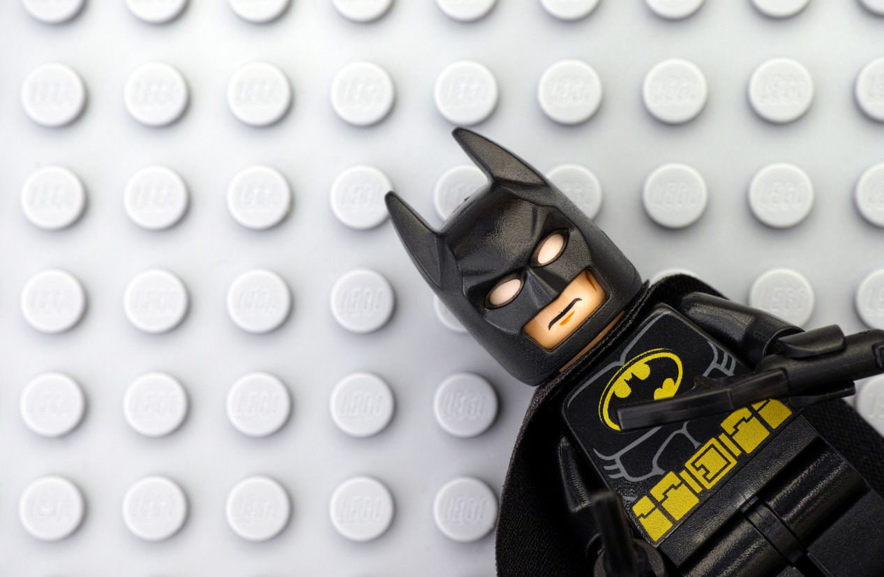 a Lego Batman minifigure on Lego gray baseplate background