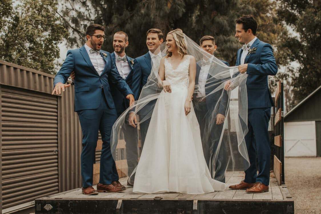 Bride surrounded by groomsmen