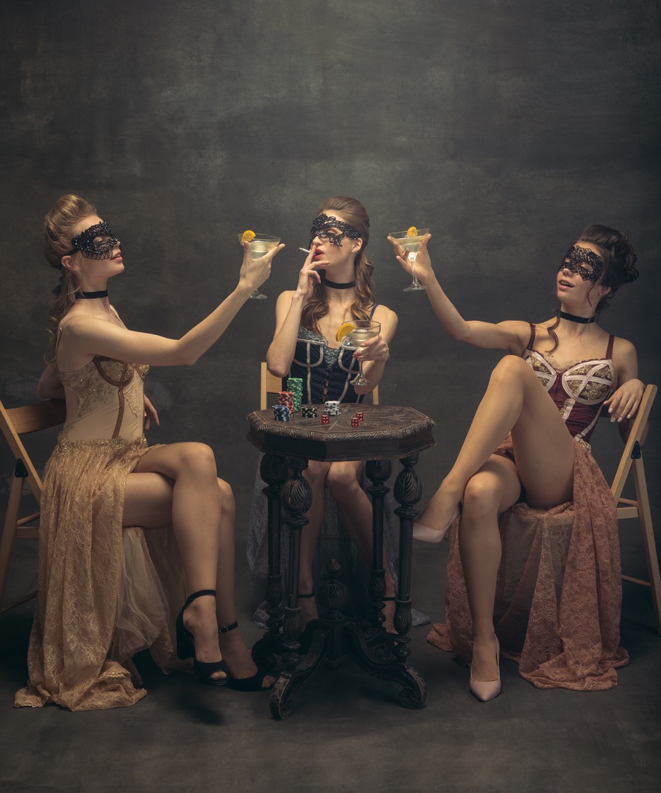 Flappers women wearing in style of Roaring Gatsby twenties drinking alcohol
