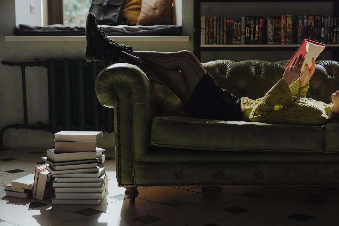 Person on the sofa reading a book
